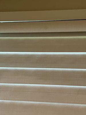 Look closely this is a brand new Hunter Douglas Pirouette there are stains throughout the blinds and this was newly installed!