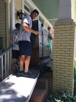 Moving an upright piano into a new apartment in Midcity