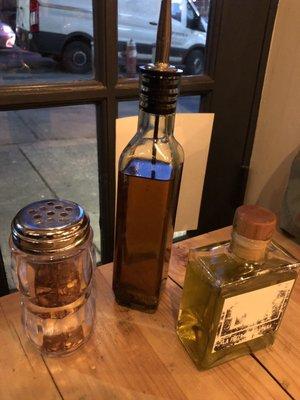 Complimentary olive oil, crushed red peppers, and spicy hot oil to go with your pizza!