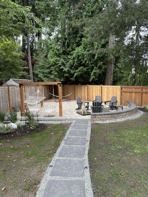 Patio with pavers and fire pit/seating area.