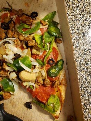 This is how the pizza looks with the veggies falling off.