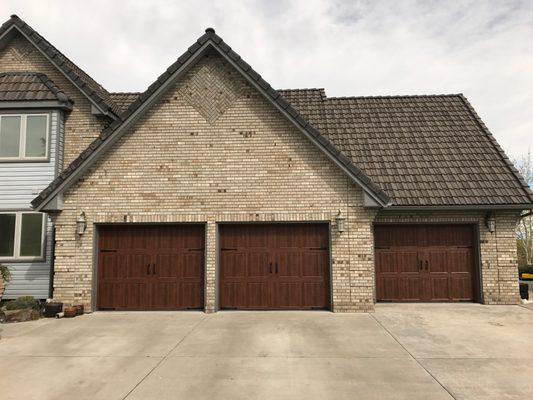 These wood grain Amarr garage doors go perfect on this Carriage style home.