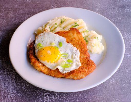 Traditional Polish Breaded Pork Schnitzel, served with fried egg and mashed potatoes