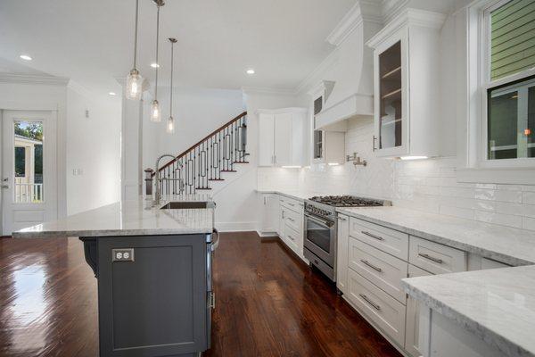 Custom designed kitchen w/classic white shaker & glass cabinets, built-in cabinet spice racks, marble counters, 36" Verona stove, pot filler