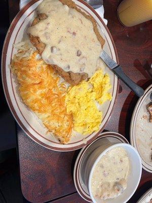 Chicken fried steak with a bowl of very dense, filling biscuit with gravy