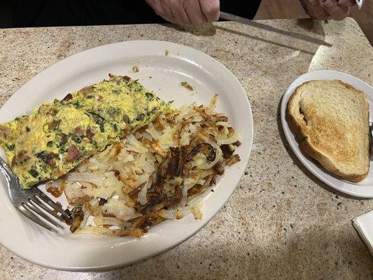 Popeye omelet with hash browns and sourdough toast