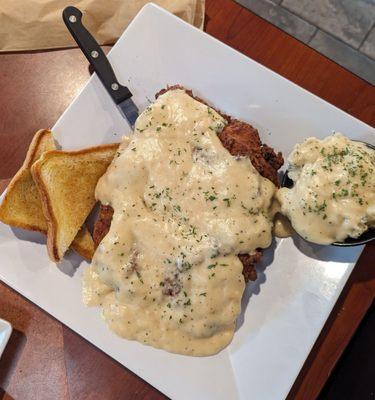 GIANT chicken fried steak and masked potatoes.