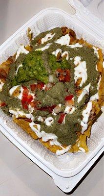 Chicken nachos with they're green sauce!