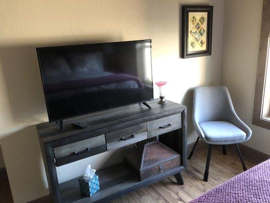 Upholstered swivel dining room chair fits perfectly in  small guest bedroom.