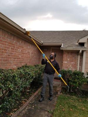 Technical is clearing out any spider eggs on the perimeter of the house and checking for wasp's nest.