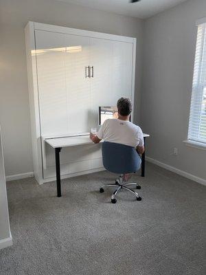 Murphy bed up & attached desk set up for use.