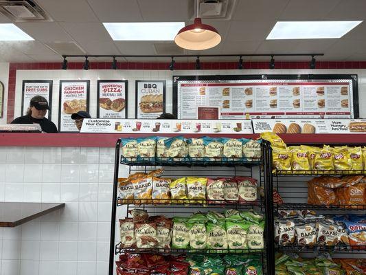 3 people making sandwiches and one on register and one helping with all of it.