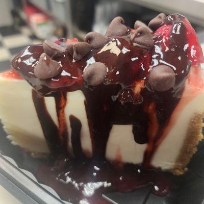 Cheesecake with chocolate and strawberry sauce