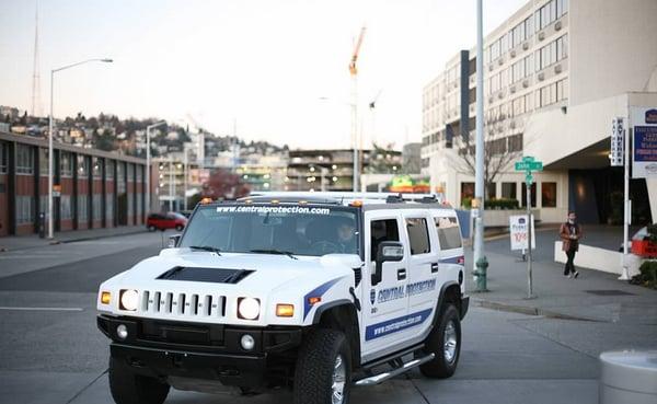 Highly visible Central Protection security patrol car with a guard inside parked in Seattle, WA.