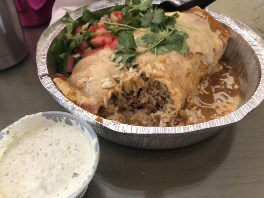 Burrito enchilada style with spicy beef and steak. Side Side of Creamy Tomatillo Dressing