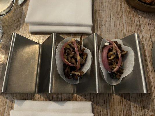 Jicama wrap tacos with mushroom and pickled onions