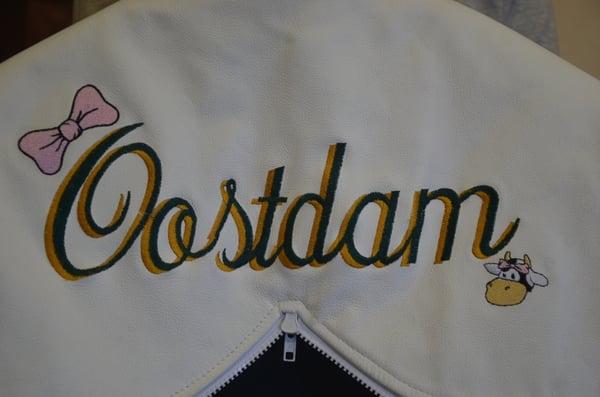 Two color shadow embroidery with logos on a custom leather hood.