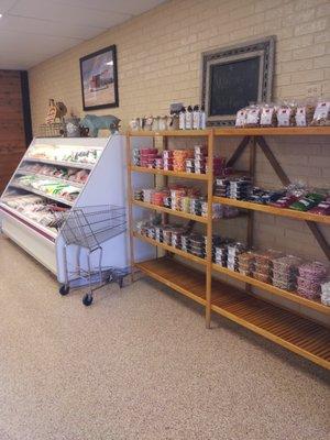 Condiments and Candies on Wooden Shelf / Packages Meats in Case