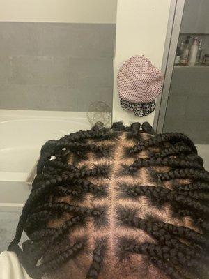 Crooked parts, poorly braided, and clearly not Knotless as you can see the braid hair was added as it would be for regular box braids.