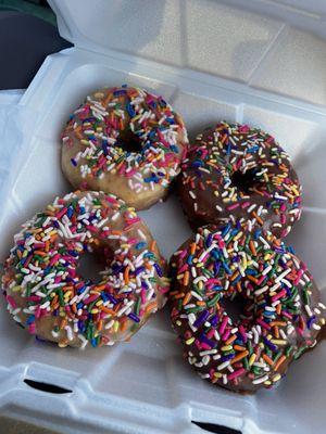 2 glazed and 2 chocolate donuts with sprinkles