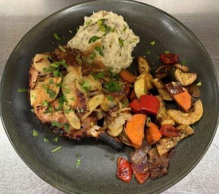 Bone in Pork Chop topped with a Bourbon Glazed Apple & Onion Chutney served with mashed potatoes and seasonal Vegetables