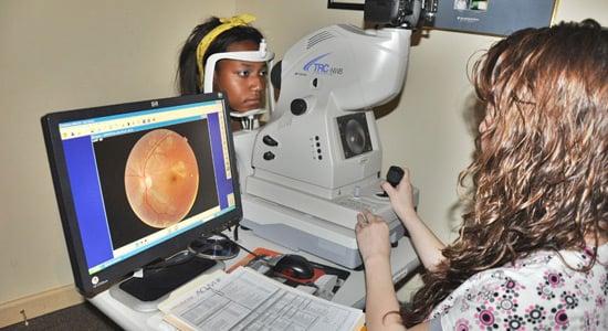 A member of our team assisting in the eye exam.