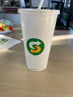 Subway cup with Cocoa Cola in it.