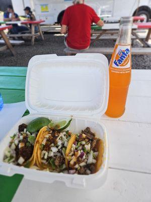 My tacos and my orange Fanta in a glass bottle