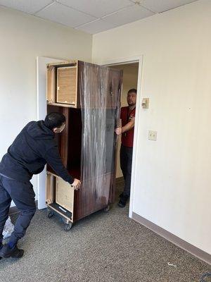 Moving wooden office desk.