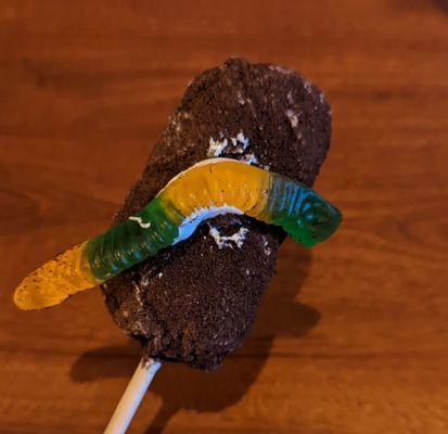 Chocolate and oreo covered marshmallow with gummy worm