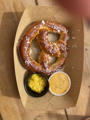 Pretzel with mustard and queso