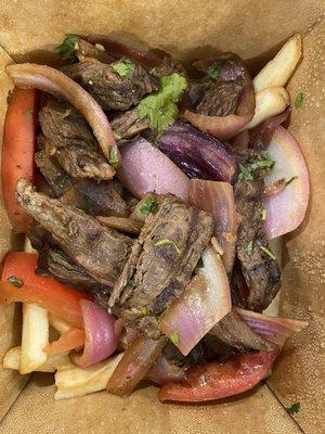 Steak with onions, tomatoes, and fries