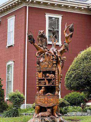 Ornate wood sculpture in front yard