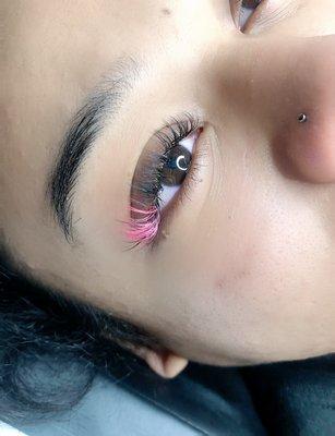 A pop of pink to her lash extensions