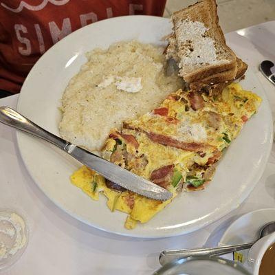 My honey enjoyed his food  Western Omelet Grits toast