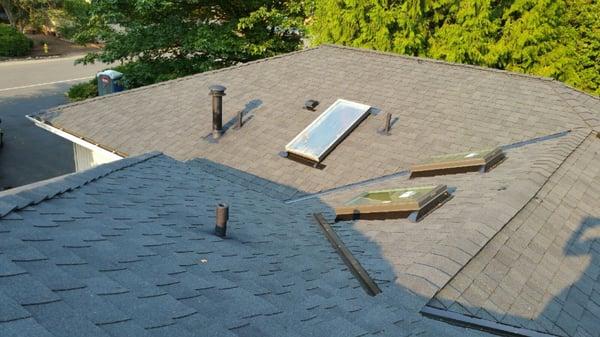 New skylights up close next to each other and the old skylight in the distance.  All flashing done properly.