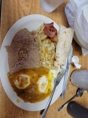 Huevos Ranchos fried potatoes w/refried beans, bacon and flour tortillas