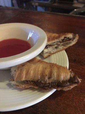 Nutella croissant with cherry sauce.