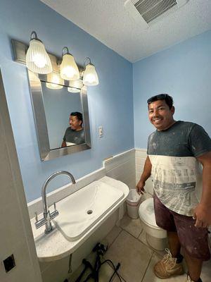 Oscar with the white quartz vanity counter he fabricated and installed.