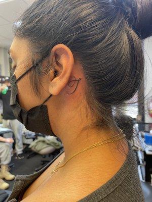 Behind the ear tattoo