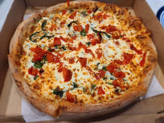 St. Nick's: ricotta infused w/ garlic & basil base, spinach, oregano, roasted red peppers, & feta cheese.