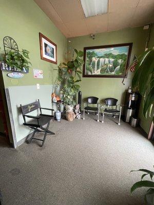 Waiting room with a water cooler. Another waiting room at the back of the center.