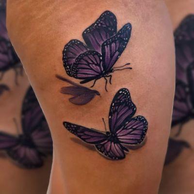 Realistic colored butterflies tattoo on thigh