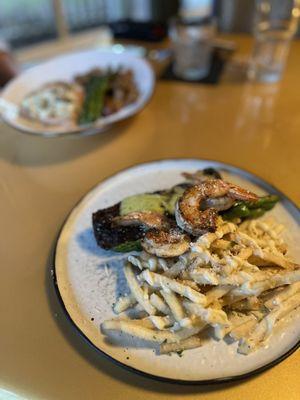 Steak and Shrimp with a chef made sauce and Parmesan truffle fries. Background: 6oz filet with grilled asparagus and whipped potatoes