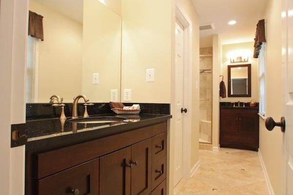 Remodeled bathrooms with granite and cherry vanities, custom trim, and tile work