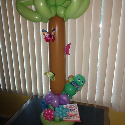 Big balloon cup. Tree with butterflies turtle standing under with flowers