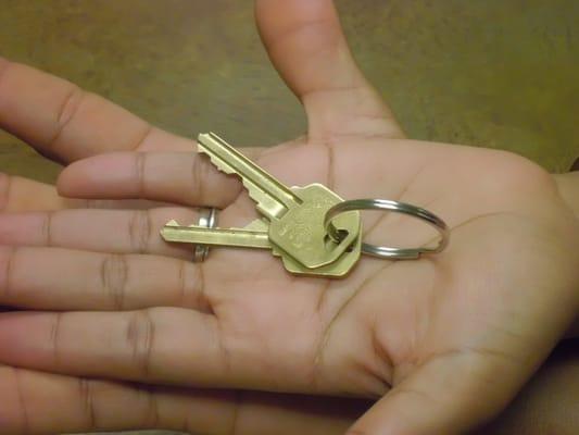 First time homebuyers holding their keys to a new home.