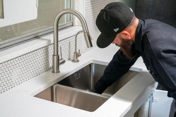 Installing a new sink drain.