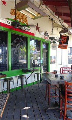 The front door is located on the deck of the restaurant, and you'll note the sports pennants and beer signs, along with the state flag.