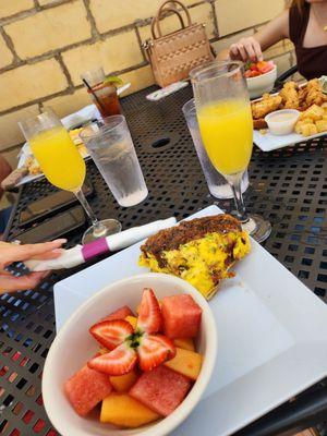 Quiche with fruit bowl covered in honey champagne.  Can't forget the mimosa!!!!